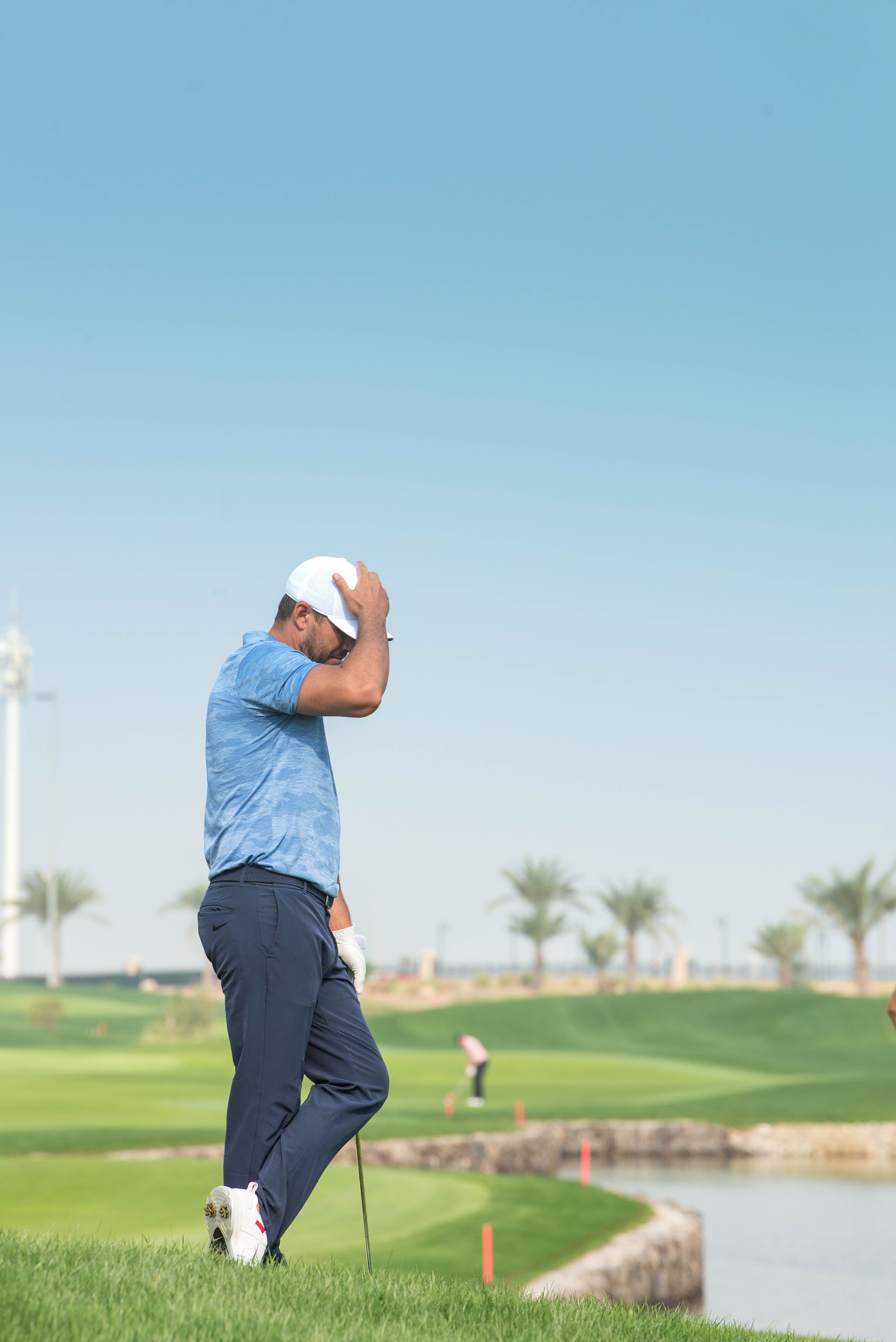 Golfer assessing a shot from thick rough